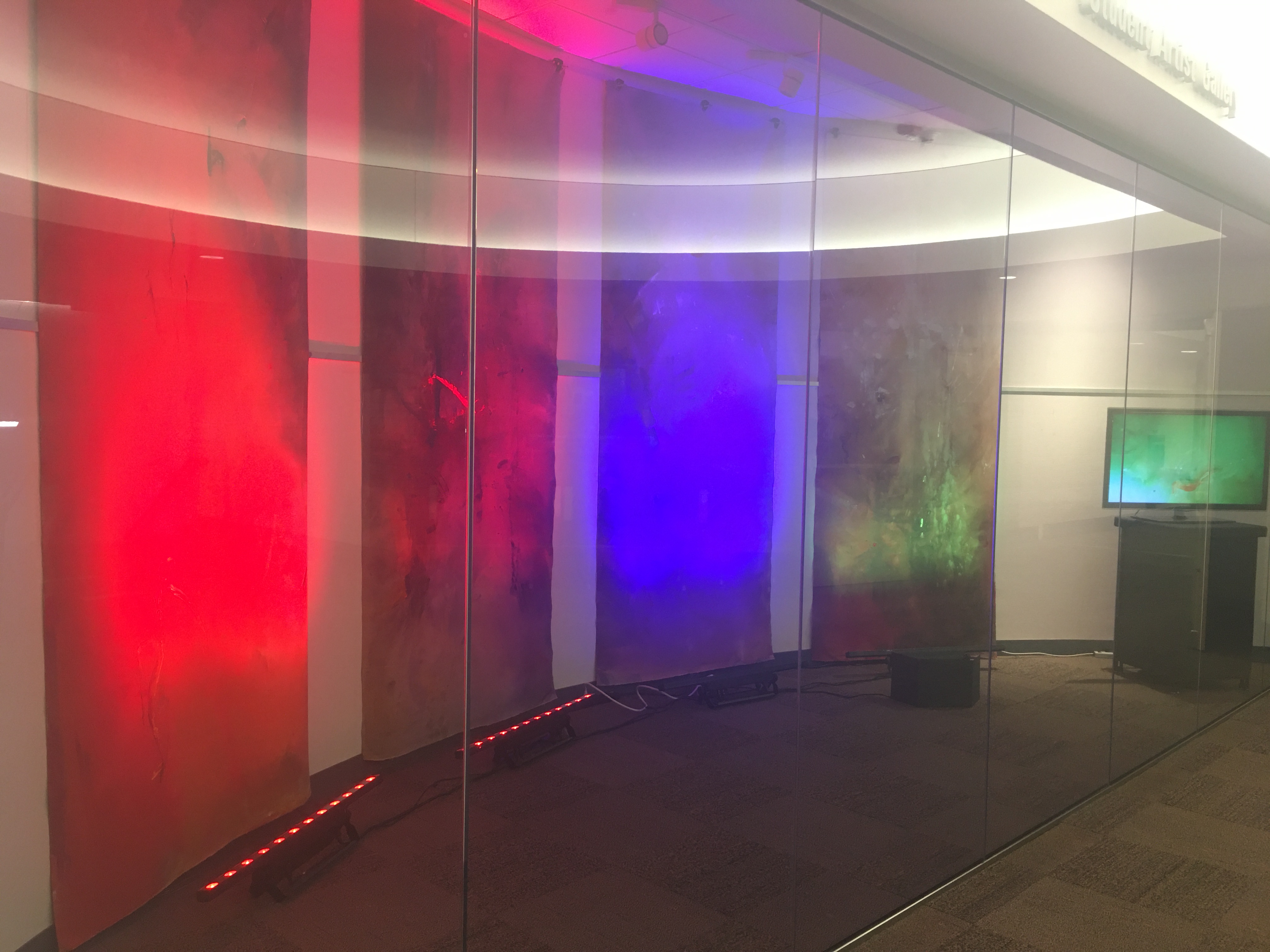 4 8x4ft paintings "connecting" with video behind glass in rotunda gallery